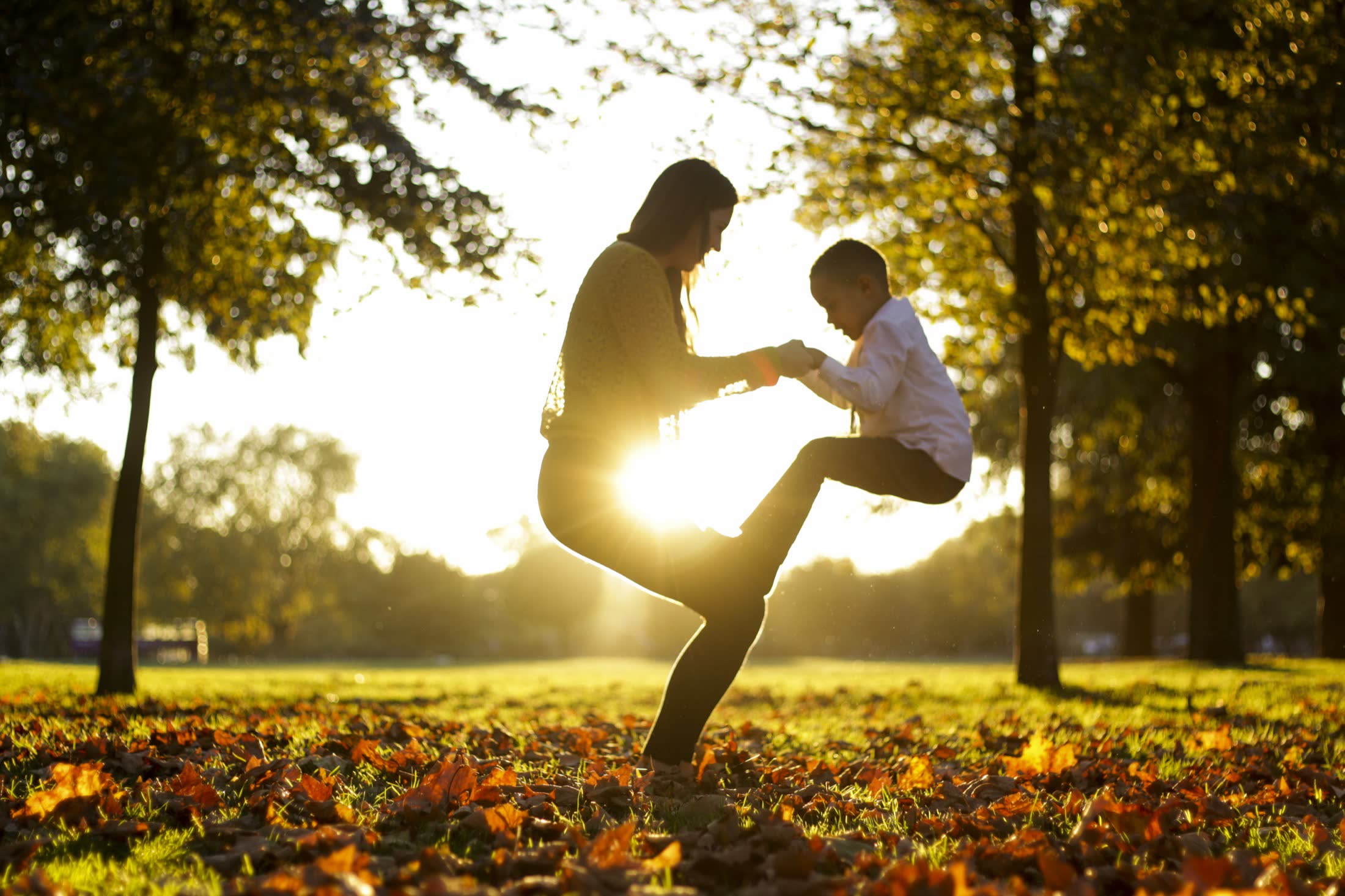 A parent and child connecting through movement outdoors