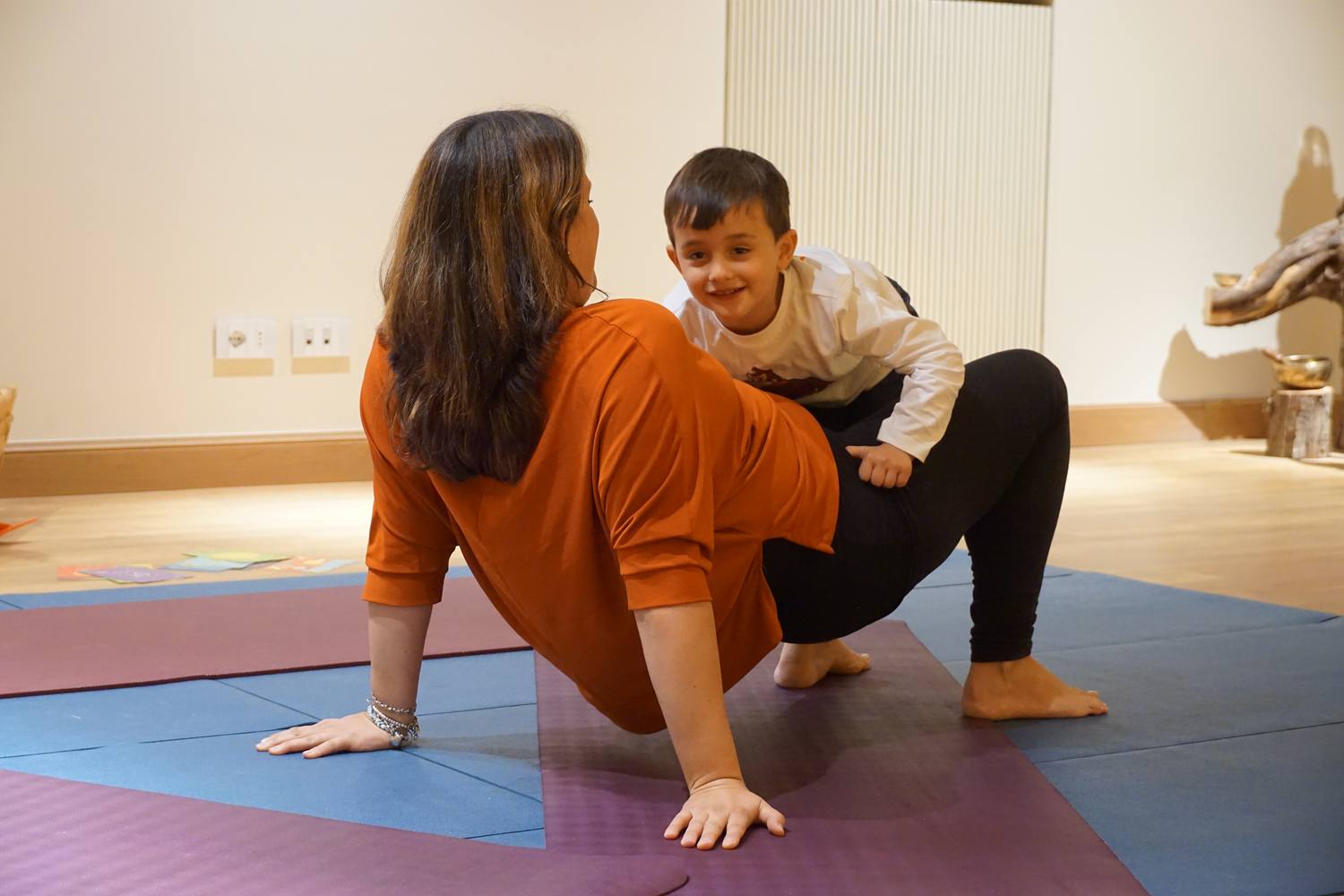 A child moving and exploring freely on the mat during an individual session