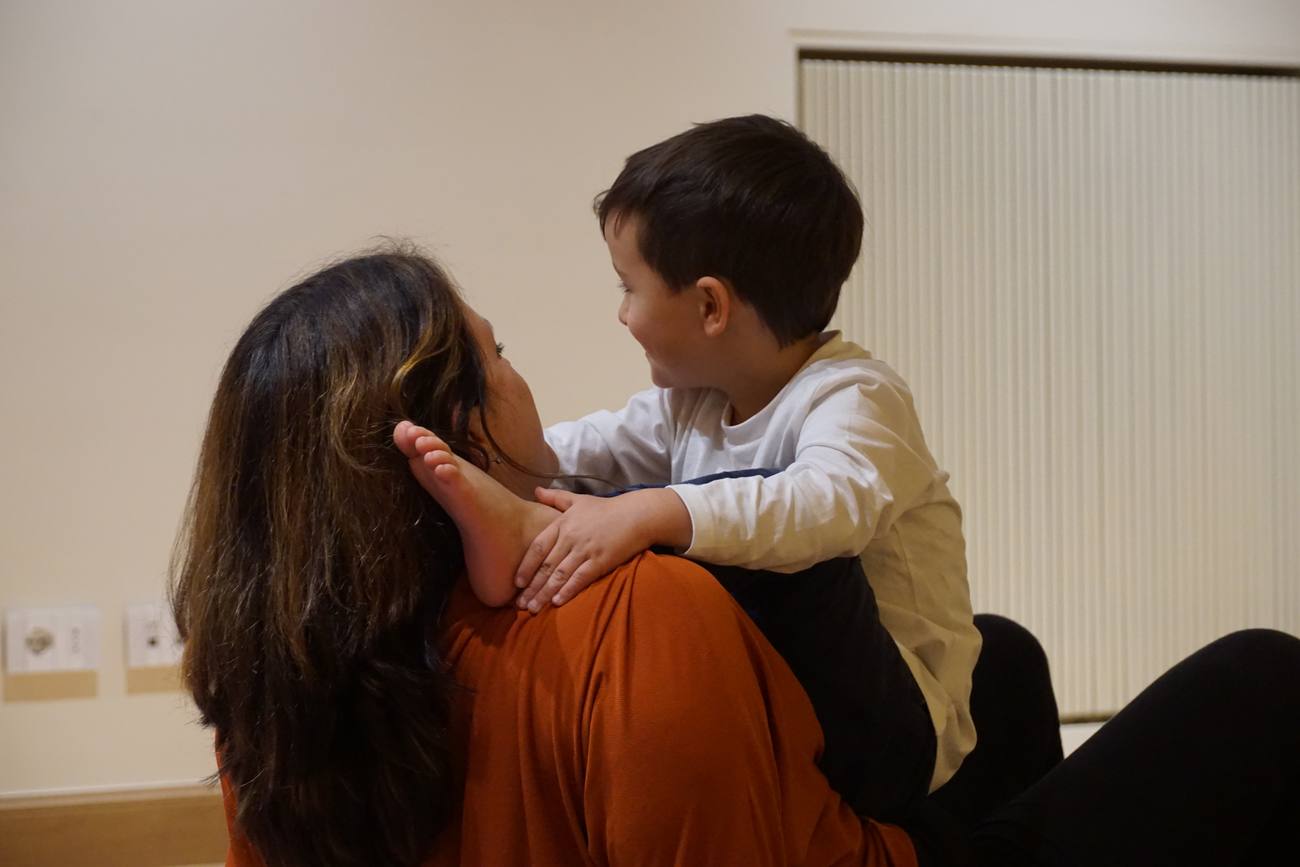 A parent and child face to face, connecting closely