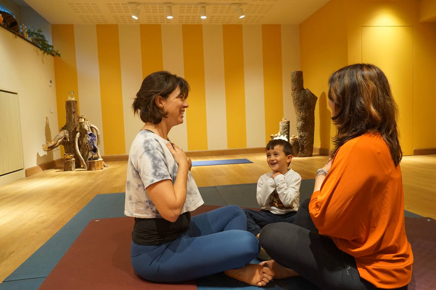 A small group circle of children and parents sharing a calm moment together