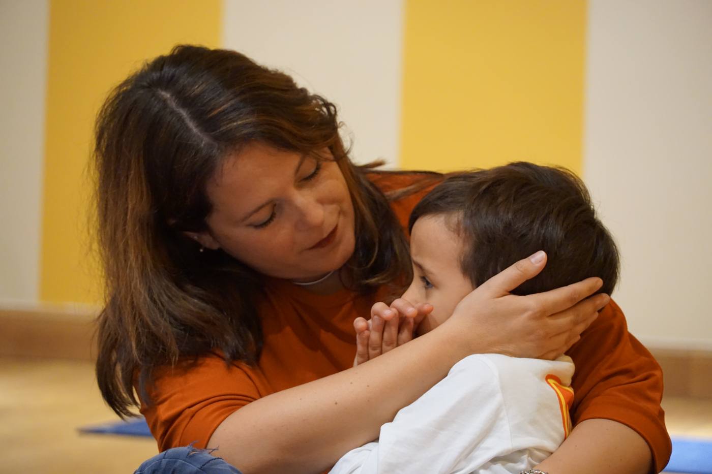 A parent and child in a close, tender moment during a session